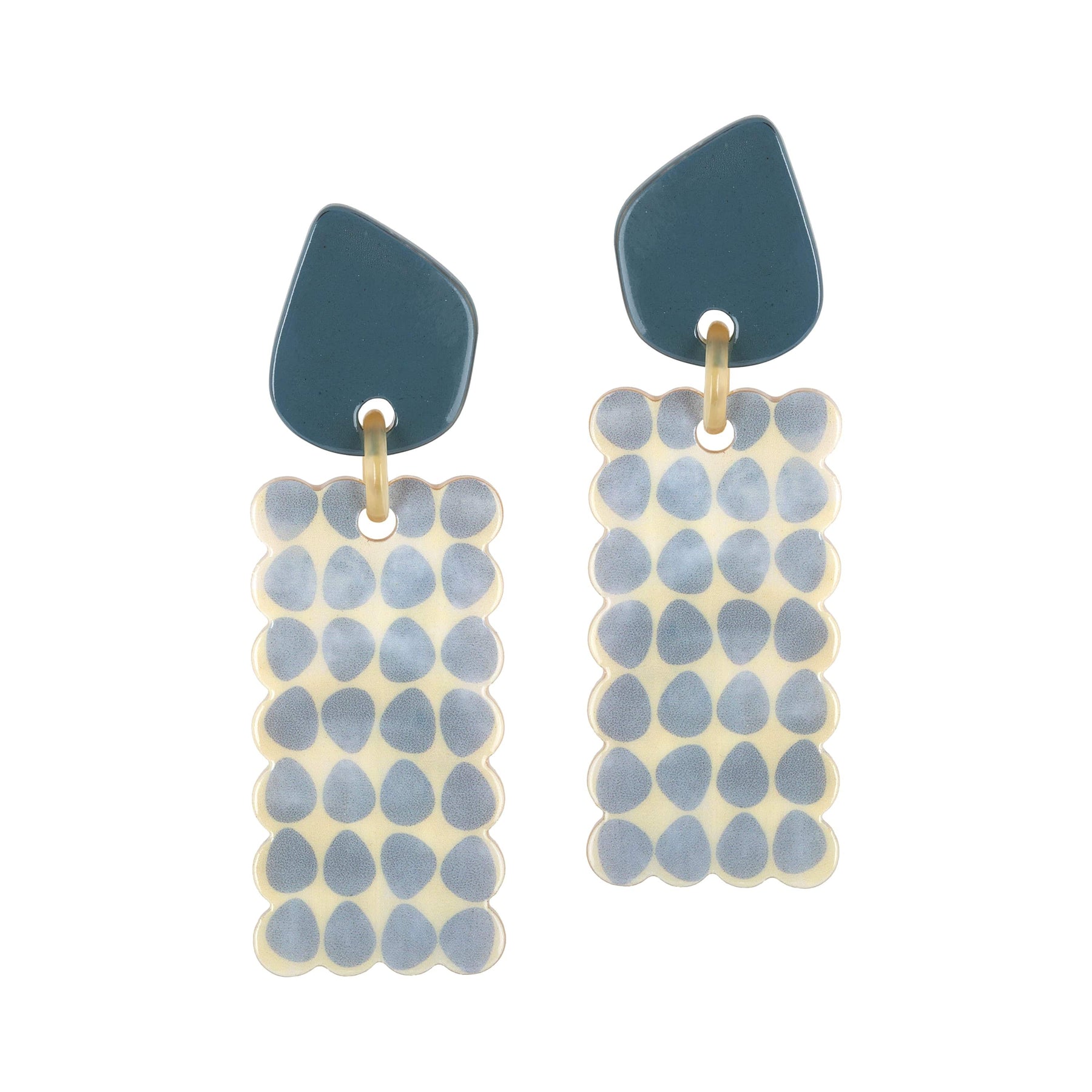 A pair of Atlantic Cabana earrings featuring white and blue color scheme with a geometric design, made from buffalo horn with stainless steel ear post.