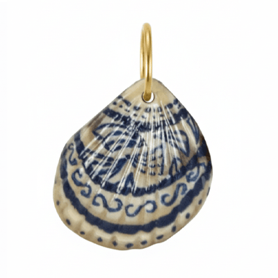 Seashell pendant with blue patterns on a white background