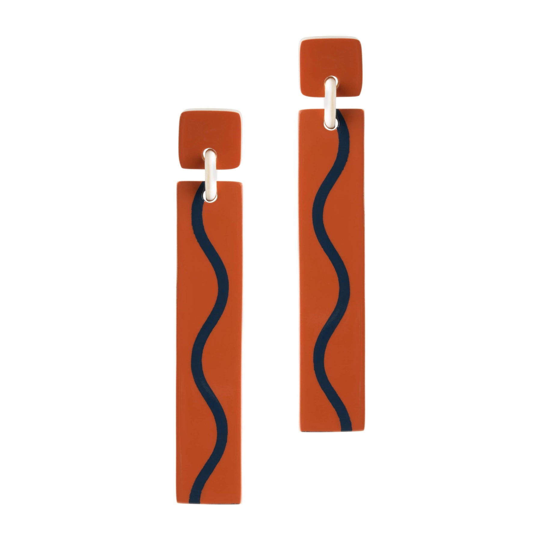 A pair of earrings featuring burnt orange colored rectangular drops with a dark squiggle line accent, attached to stainless steel ear posts.