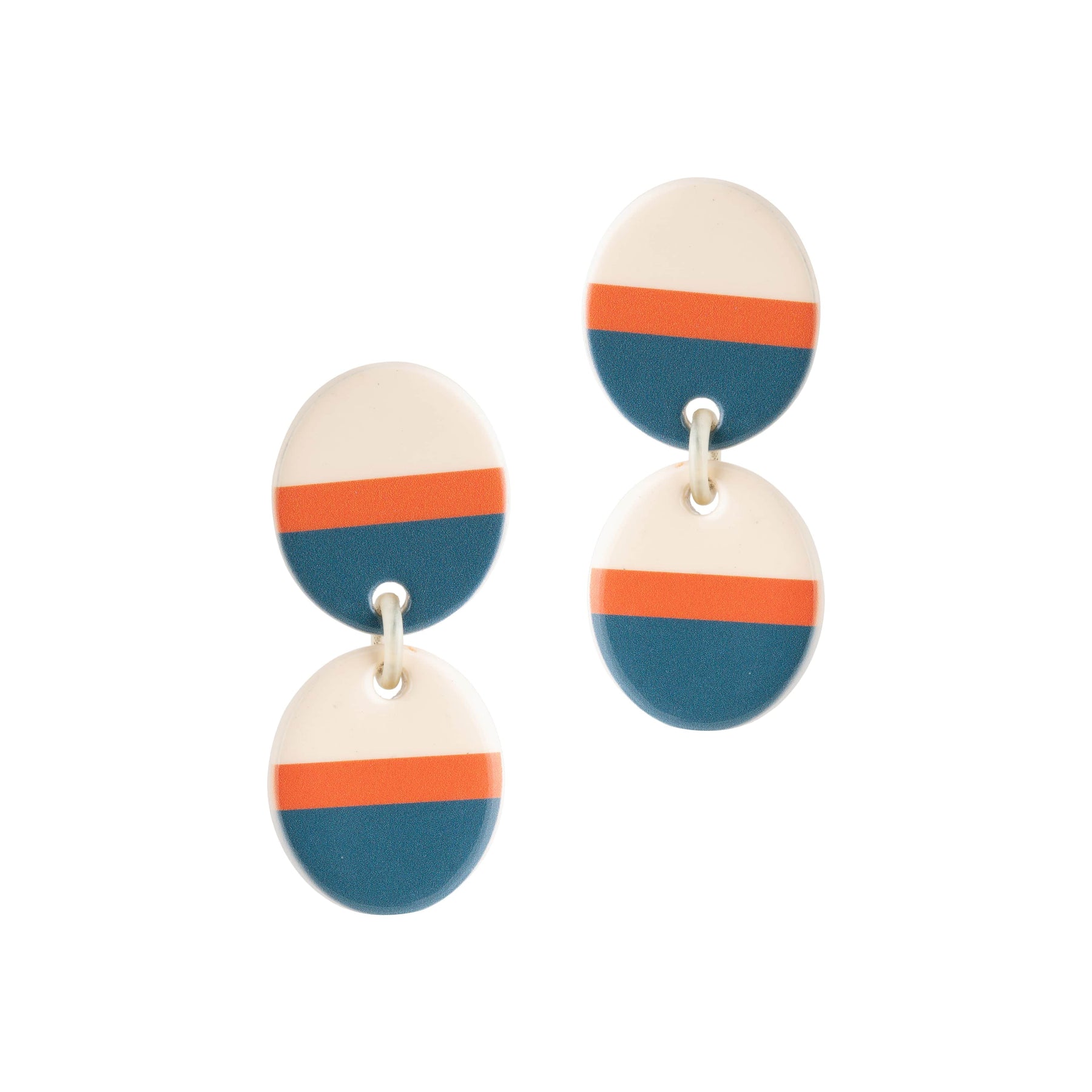 A pair of earrings featuring a colorblock design with ivory, orange, and teal colors on a circular shape, connected by a stainless steel ear post.
