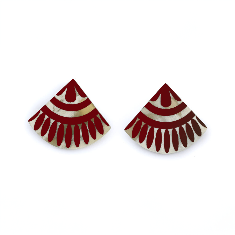 A pair of cranberry tile earrings with a geometric pattern, made from buffalo horn with stainless steel ear posts.