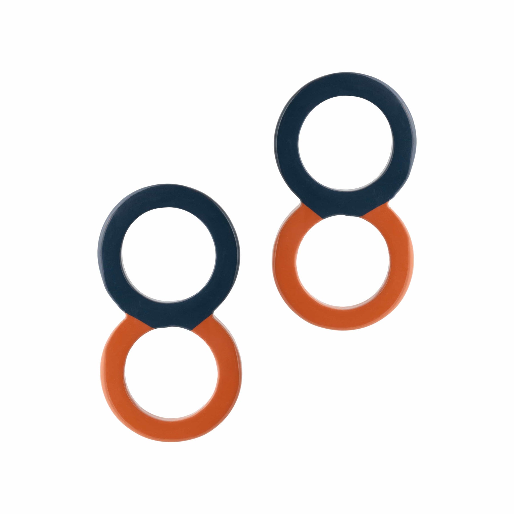 A pair of navy and orange circle stud earrings.