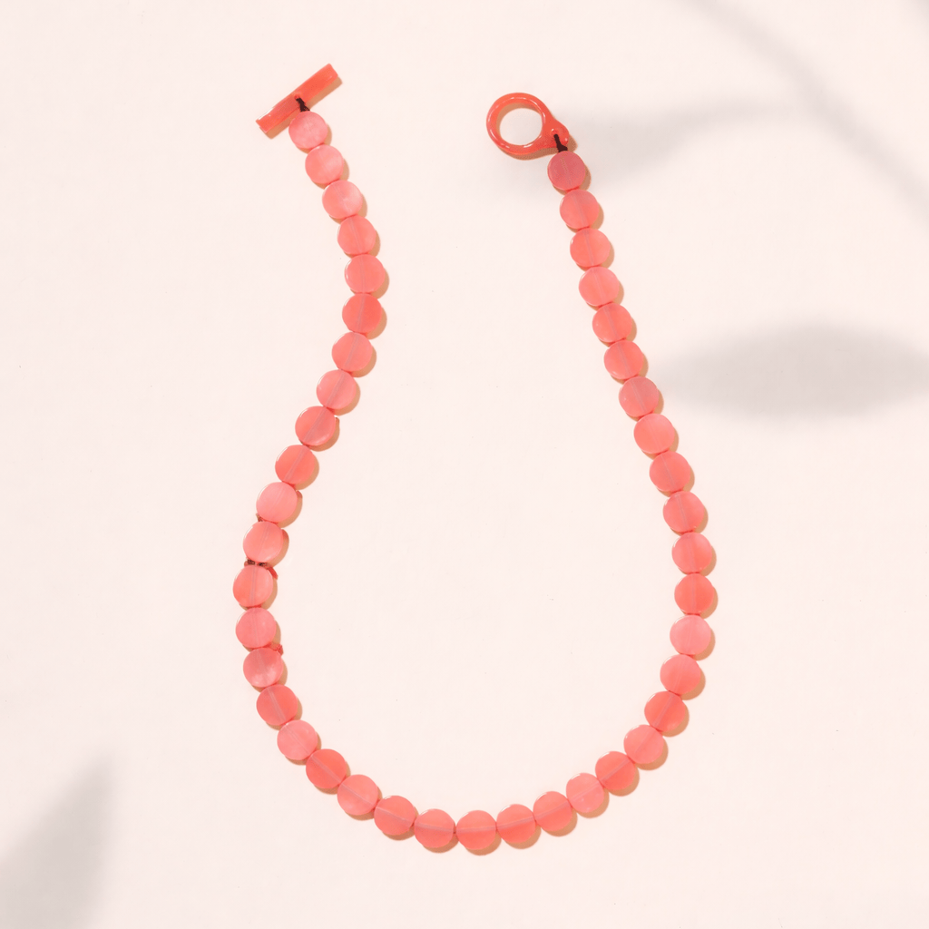 Necklace with pink beads on a white background