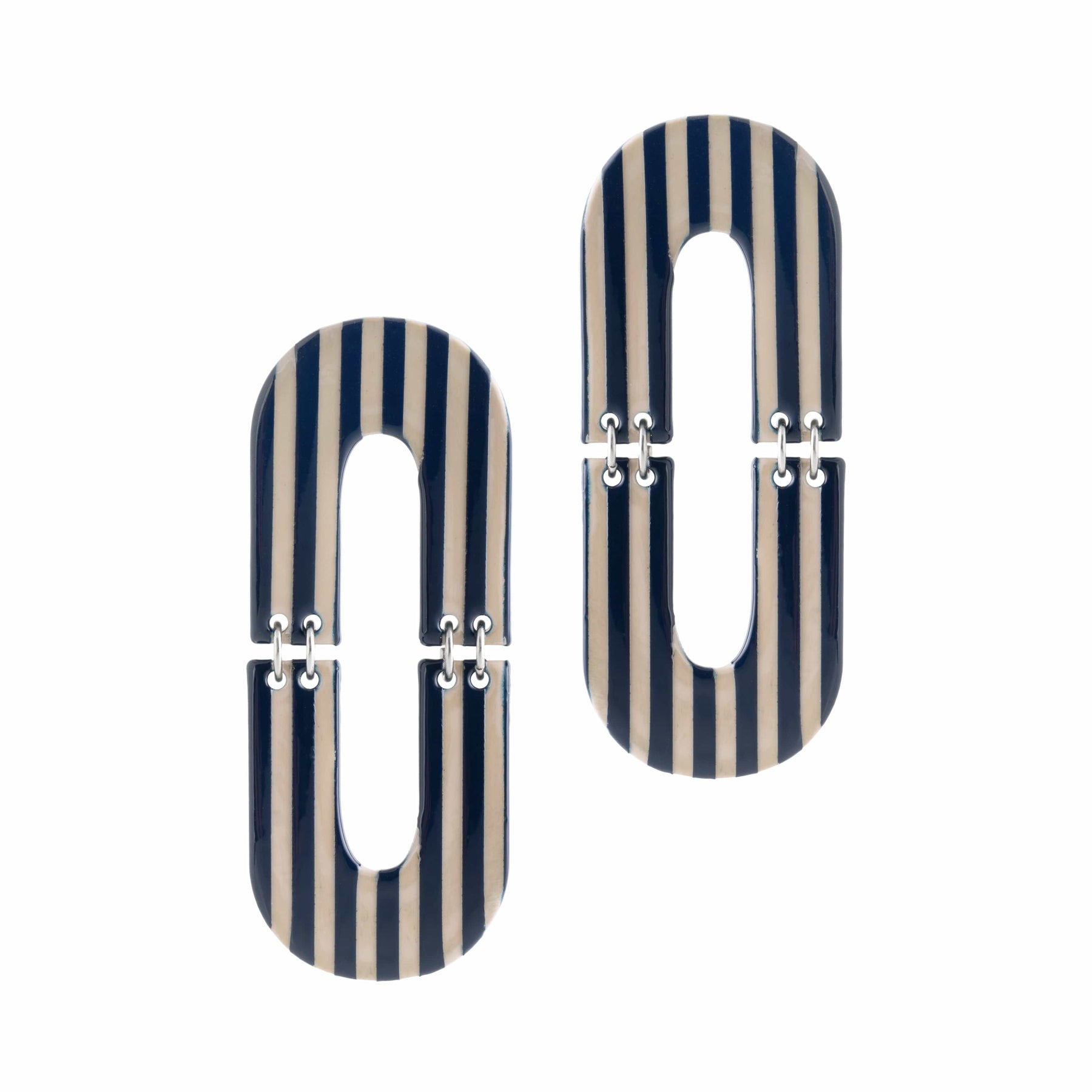 A pair of oval-shaped earrings with black and white stripes, made from buffalo horn with stainless steel ear posts.