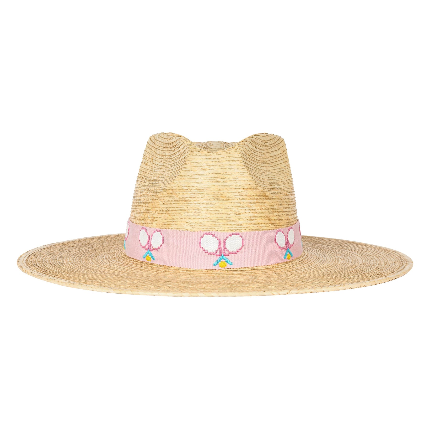 A straw hat with a pink band and embroidered tennis rackets on it, standing on a tennis court.