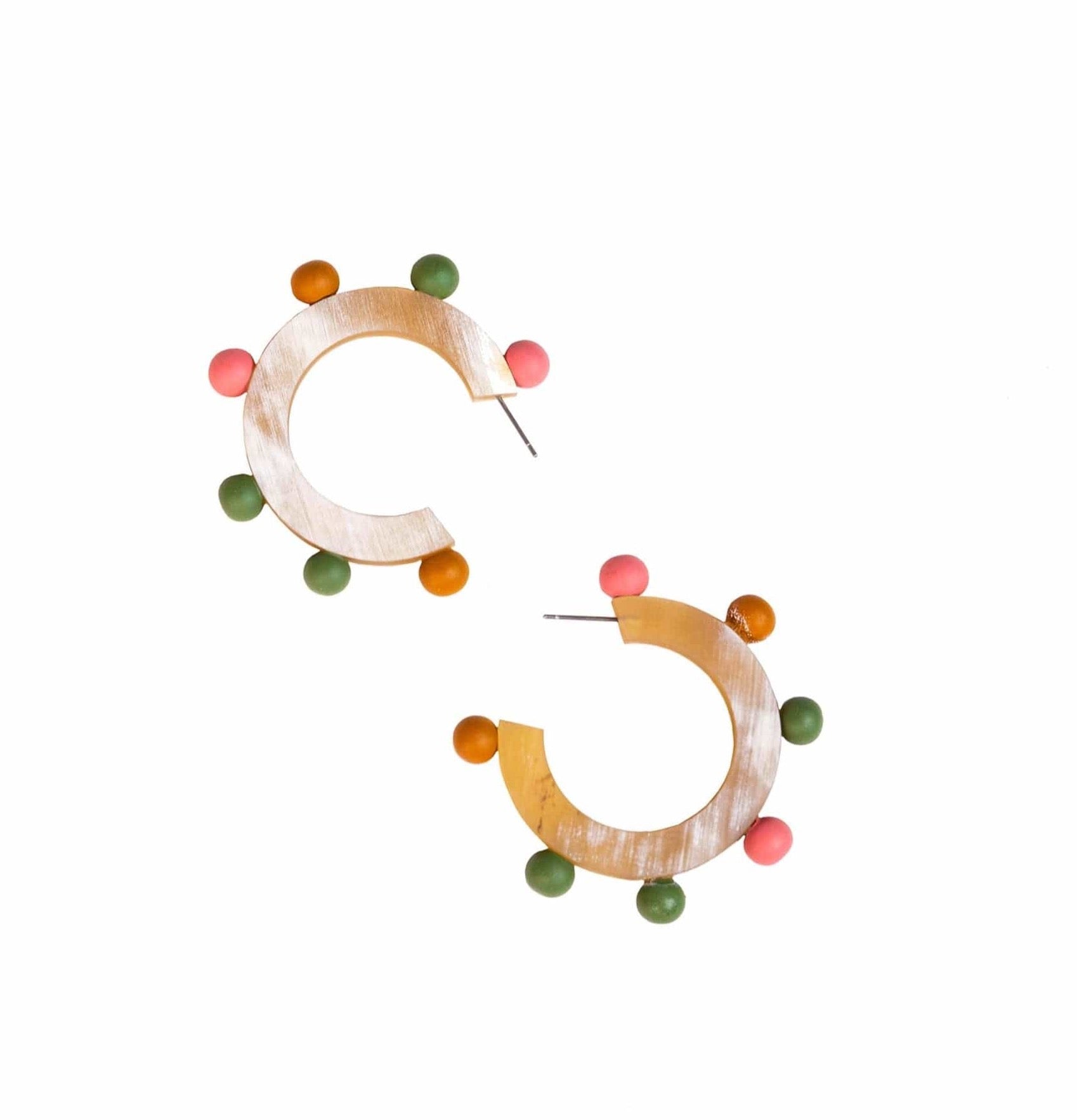 A pair of earrings featuring autumnal colored beads in a hoop design with buffalo horn material and stainless steel ear posts.