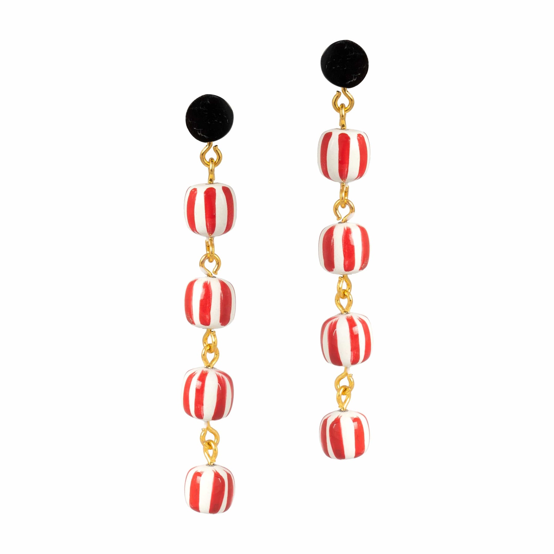 Pair of earrings with red and white striped beads and black tops on a white background