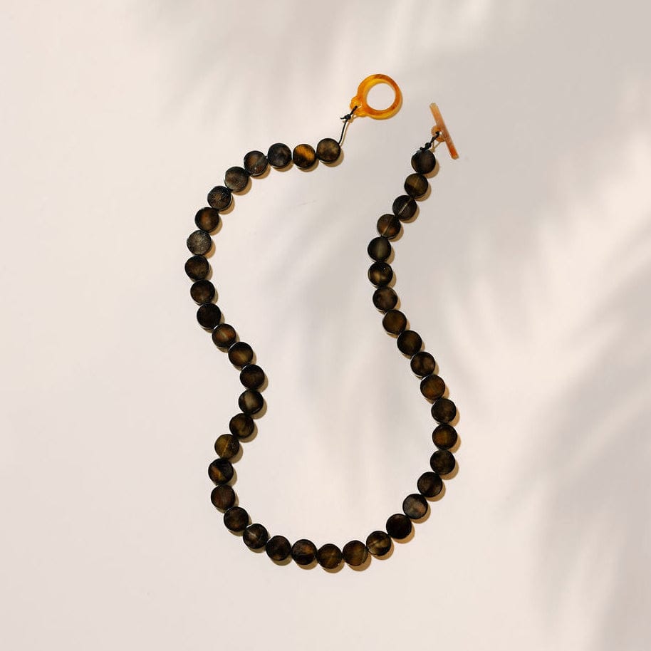 Beaded necklace with a clasp on a light gray background