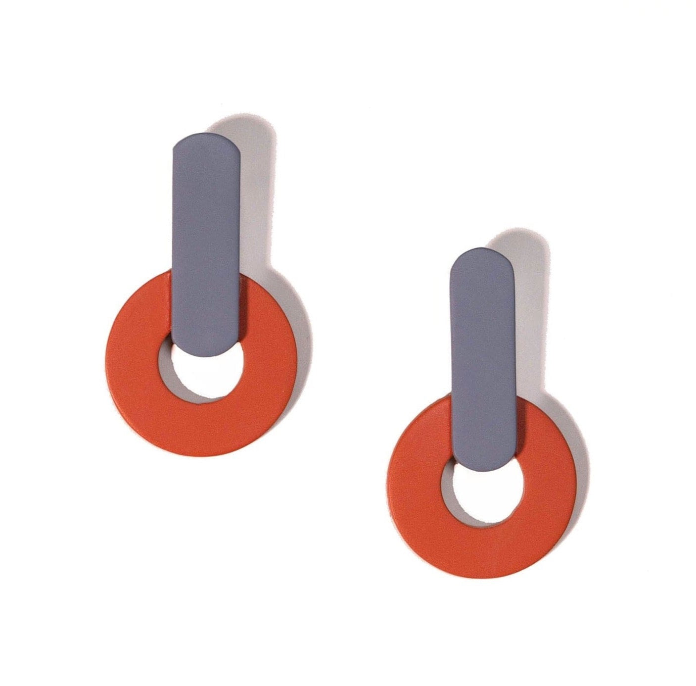 A pair of earrings featuring geometric shapes with a combination of burnt orange and periwinkle colors, with a sleek and modern design.