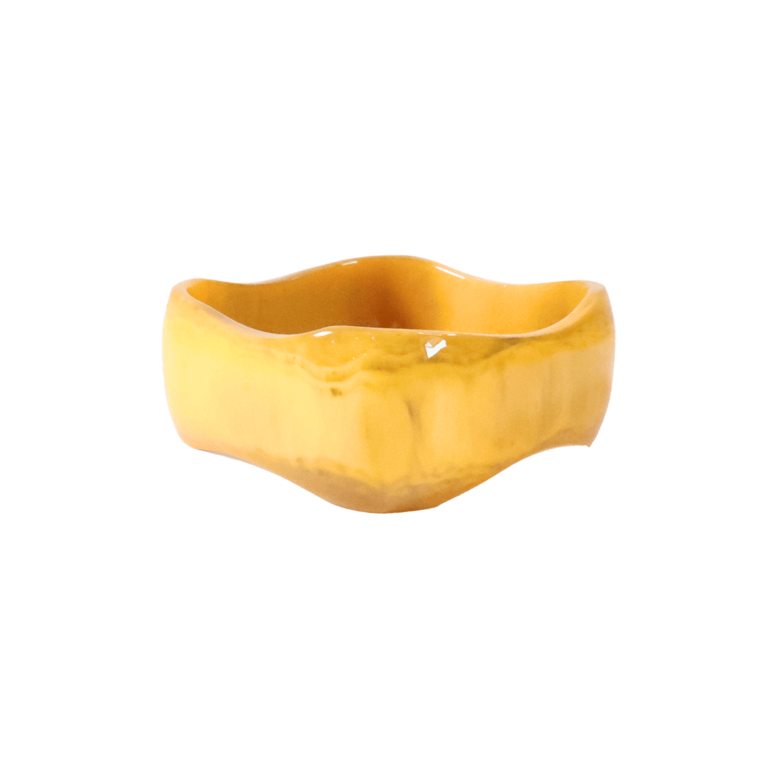 Yellow ceramic bowl on a white background