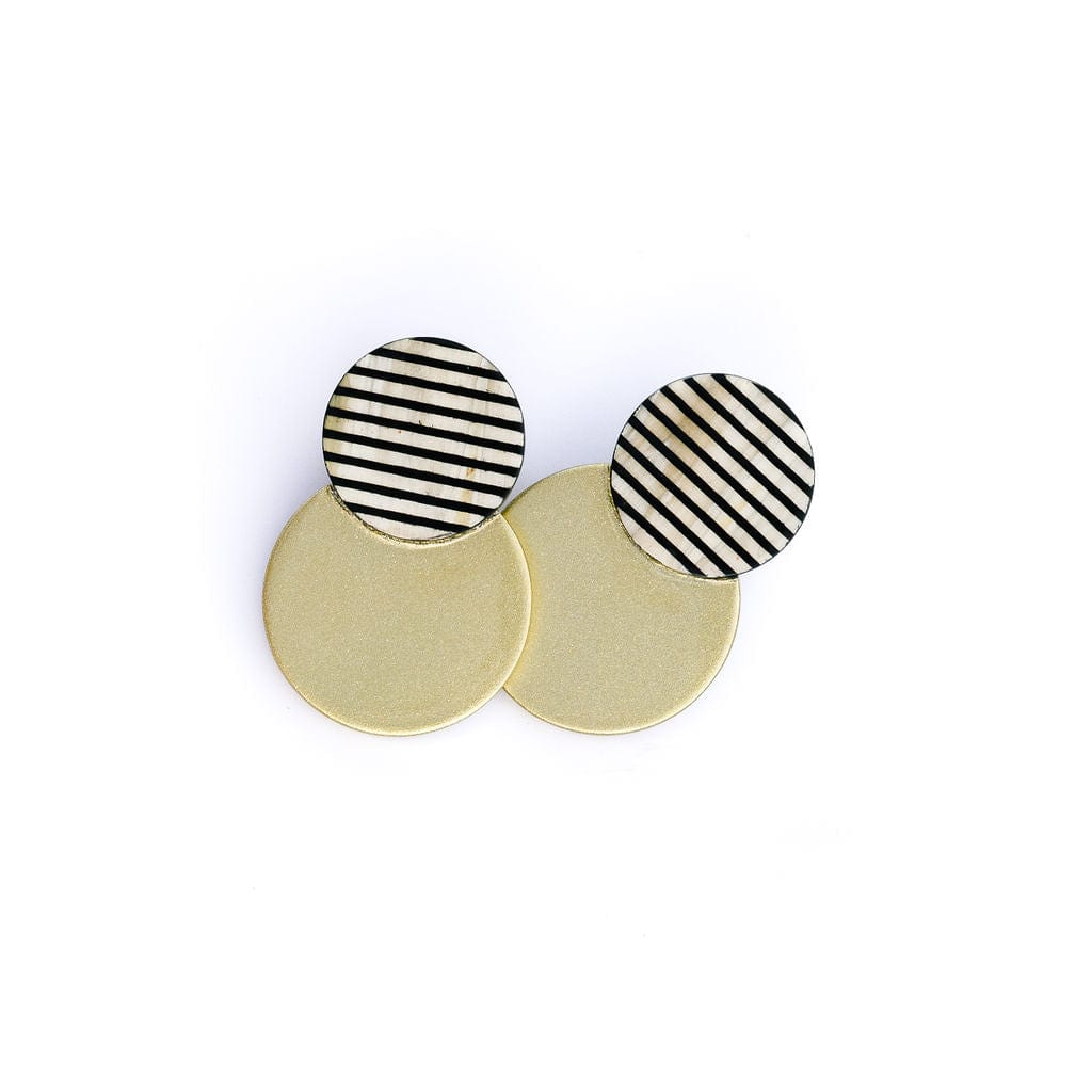 A pair of gold tuxedo stripe circle earrings with black and white striped details, displayed on a white background.