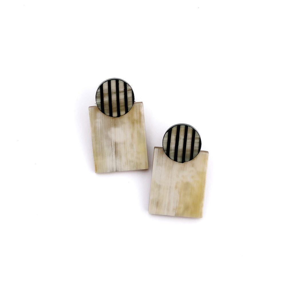 A pair of earrings featuring geometric shapes with a black and white striped pattern on the top circle and natural buffalo horn on the bottom rectangle.